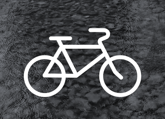 weißes Fahrrad vor einem grauen Hintergrund mit Wassertropfen